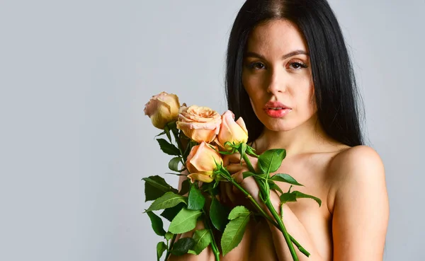 Spa treatments for skin rejuvenation. sexy naked woman hold rose flower. soft and tender. healthy woman hold rose with petals. sexy nude beautiful woman in flowers. love and romance. copy space — Stock Photo, Image