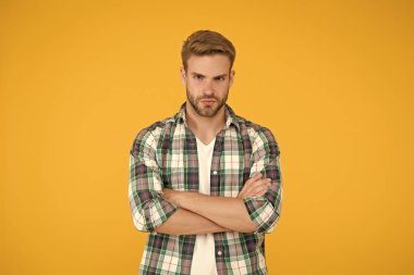 Erkek güzellik standartları. Erkeksi kıyafetler ve bak. Şık giyinmiş şık bir erkek. Kareli gömlek ve kot pantolon giymiş yakışıklı bir adam. Kendine güveni olan sarı öğrenci. Erkekler için gündelik moda