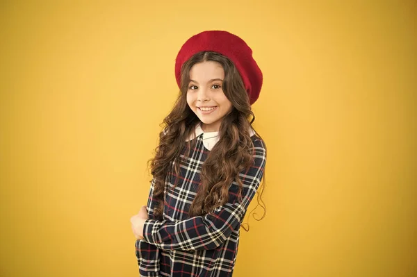 Alegria pura. criança menina pequena com cabelo encaracolado longo. menina feliz em boina francesa. criança no fundo amarelo. uniforme escolar elegante. moda infantil. menina da moda parisiense. dia das crianças — Fotografia de Stock