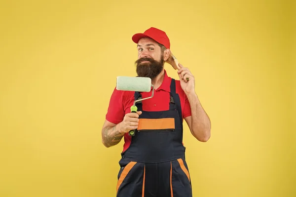 Professional skills. brutal hipster try to be craftsman. professional repairer. serious builder man. bearded worker. Hard worker with painting brush and roller. Construction worker ready to work — 스톡 사진