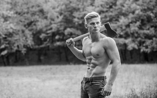 Doing his best. man strong body. muscular man with axe. sexy macho bare torso ax. brutal and attractive male in wood. bodybuilder show his muscles. power and strength. lumberjack carry axe — Stock Photo, Image