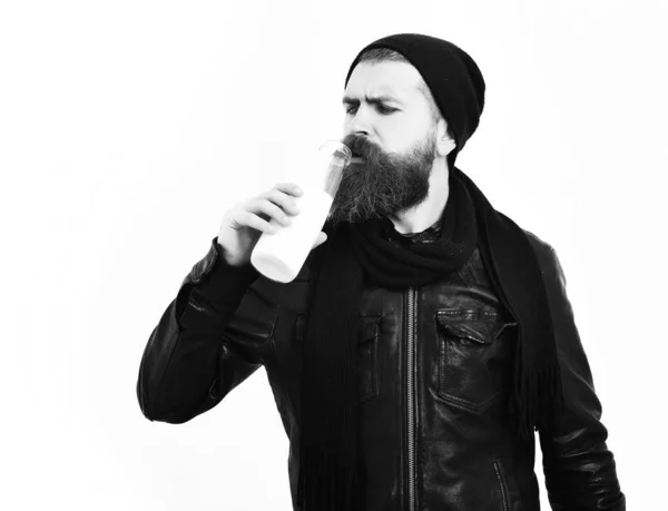 Bearded brutal caucasian hipster holding glass jar of milk — Stock Photo, Image