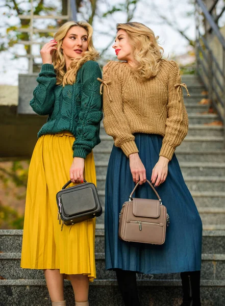 Autumn snuggles. female beauty. knitwear fashion for youth. charm. stylish autumn women. girl friends go upstairs. fall season color trends. Pleated trend. girls in corrugated skirt and sweater — Stock Photo, Image