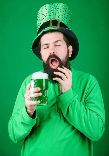 Man brutal bearded hipster drink beer. Irish pub. Drinking beer part celebration. Fest and holiday menu. Dyed green traditional beer. Lets start patricks party. Alcohol beverage. Irish tradition