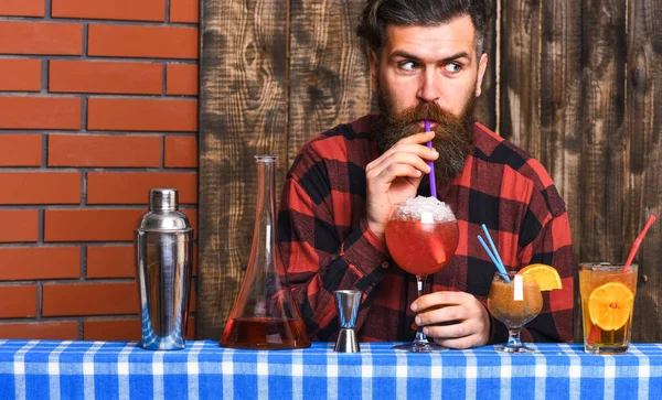 Barman com barba e rosto surpreso bebe de vidro — Fotografia de Stock