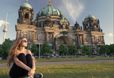 Berlin Katedrali yakınlarındaki Almanya 'da oturan düşünceli bir turist kız. Berlin Katedral Manzarası Almanya 'da oturan bir kızla birlikte. Yarının dünyasını inşa etmek. Avrupa 'yı dolaşmak. Hayat harika..