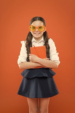 Bu benim kitabım. dizüstü bilgisayar ile küçük çocuk. edebiyat dersi eğitimi. çalışma kitabında yazma. çocuk edebiyatı. kitaptan bilgi almak. üniforma ve parti gözlüklü mutlu okul kız