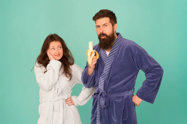 Improving potency naturally. Sexy woman look at bearded man eating banana. Sexual potency. Couple in love blue background. Male potency diet. Blow job and oral sex. Mens health and potency — Stock Photo, Image