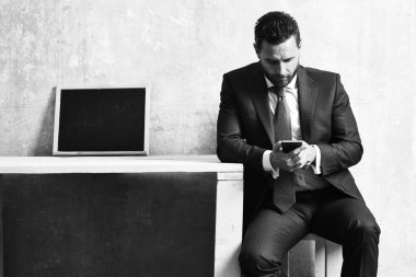 İş görüşmesi, akıllı telefonu ve tahtası olan bir iş adamı.