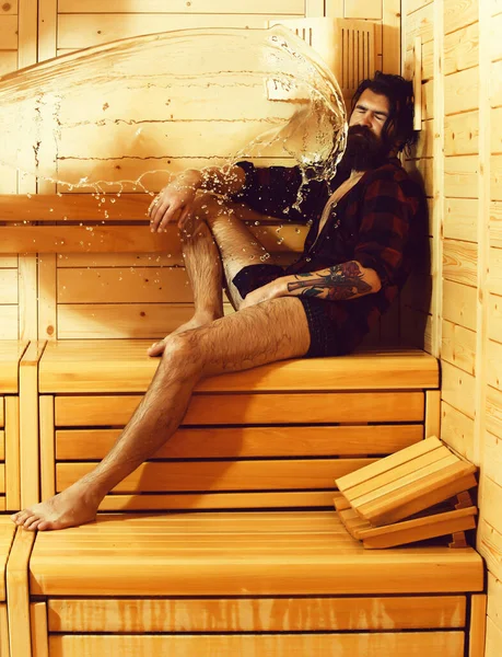 Splash van water op de mens op houten achtergrond — Stockfoto