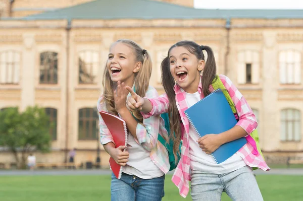STEM summer camps and courses for kids. Happiness and joy. Smiling friends having fun at school yard. Happy schoolmates. School camp. Modern education. Teens with backpacks. Girls school background