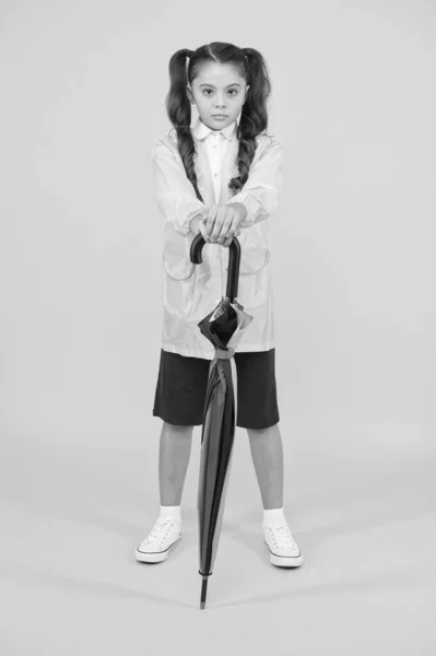 Accessory for fall season. autumn kid fashion. dry and comfortable in rainy weather. small girl in raincoat with umbrella. schoolgirl waterproof raincoat. feel protected and happy — Stock Photo, Image