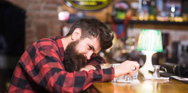 Man with tired face sit alone at bar counter