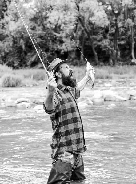Real happiness. mature man fly fishing. man catching fish. summer weekend. Happy fly fishing. bearded fisher in water. fisherman show fishing technique use rod. hobby and sport activity — Stock Photo, Image