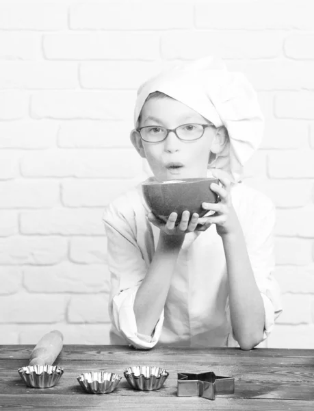 Stained cute cook chef boy on brick wall background — Stock Photo, Image