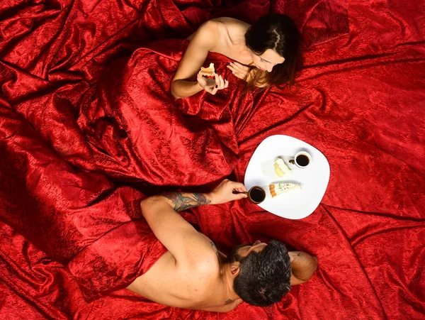 Perfect morning and love. Couple in love on red sheets