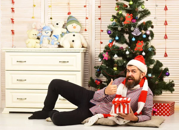 Man with beard holds box. Santa Claus with happy face — Stock Photo, Image