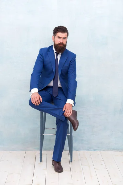 Fashion clothes shop. Classic outfit. Business leader traits. Ability to understand own strengths and weaknesses. Confident businessman sit on chair. Fashion look of manager. Formal fashion style
