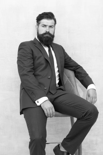He is sure to impress. Confident businessman. Businessman sit on chair. Bearded businessman in formal style. Businessman with beard and mustache hair. Smart and professional look. Business dress code