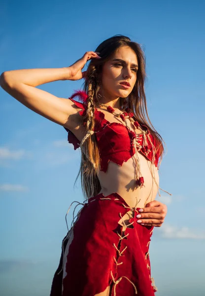 ethnic tribal fashion. female being cougar. sexy woman wear suede leather. hot summer weather. wild and dangerous. beautiful hairstyle. sensual amazon woman sky background