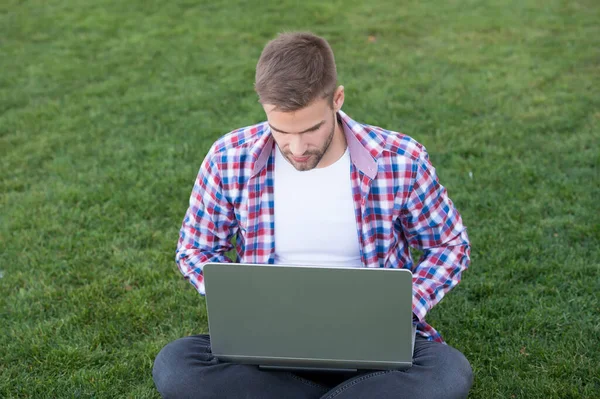 Millennial create business. Modern business. Modern technologies. Student studying on meadow. Online communications. Surfing internet. Man looking laptop screen. Talented developer. Business startup — Stock Photo, Image