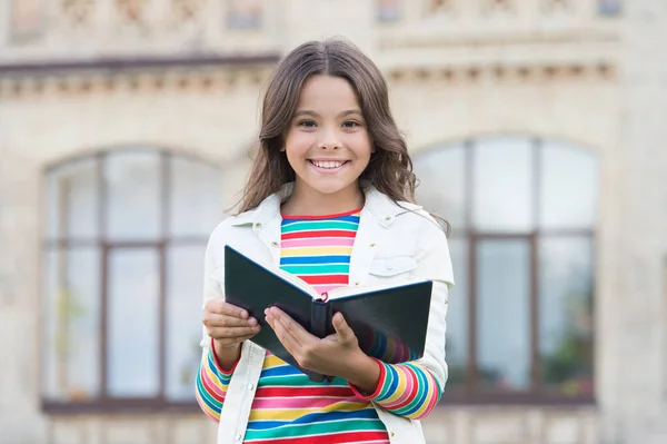 Biblioteca da escola. Estudar literatura e linguagem. Dia do conhecimento. Conceito de inspiração. Vincule seus livros favoritos e ame a literatura. Criança segurar biblioteca livro ao ar livre. Menina vai para a biblioteca — Fotografia de Stock