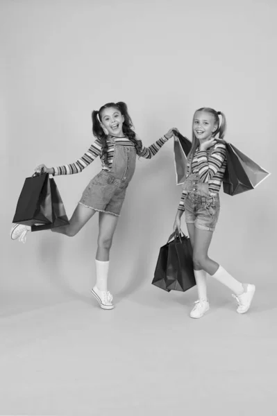 Compras de verão. Conceito de consumidor comprador. Venda total. Moda infantil. Poupança de compra de férias. Compras em casa. Meninas pequenas com sacos de compras. Vendas e descontos. Filhos felizes. Meninas com presentes — Fotografia de Stock