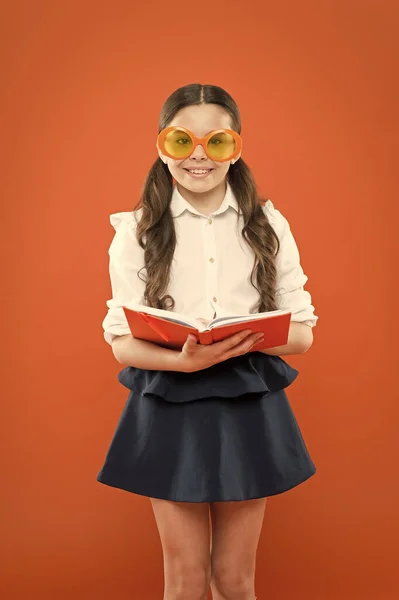 Study foreign language. Study literature. Pupil likes study. The more you know the more you grow. Small girl enjoying her school time. Happy little schoolgirl ready for lesson. Cute child with book