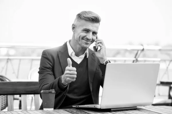 Technology as business necessity. Businessman show thumbs up. Man use mobile and computer technology. New technology. Modern life. Business communication. Technology approved by professionals — Stock Photo, Image