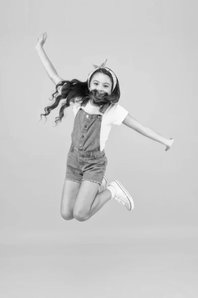 Spirit of freedom. Active girl feel freedom. Fun and relax. Feeling free. Carefree kid. Summer holidays. Jump of happiness. Small girl jump yellow background. Enjoy freedom. Childrens day concept — Stock Photo, Image