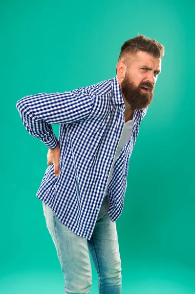 Bent over feeling sharp pain in back. Bearded man suffer from pain shoots. Back posture. Back bone. Back pain prevention. Health care. Medical problem. Complaint and disease. Trauma and injury — Stock Photo, Image