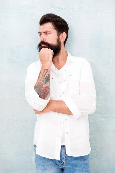 sexy model posing. bearded man wear white shirt. male casual fashion. summer collection. thoughtful male model in white shirt. brutal caucasian hipster with moustache. handsome man with beard