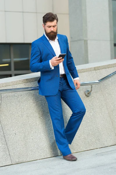 I can not imagine life without smartphone. Text messaging. Mobile communication. Contact list. Online business. Bearded man with smartphone. Handsome cool businessman using smartphone. Send message