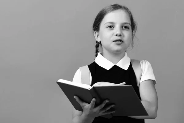 Pupil in school uniform with braid. Girl with happy face — Stock Photo, Image