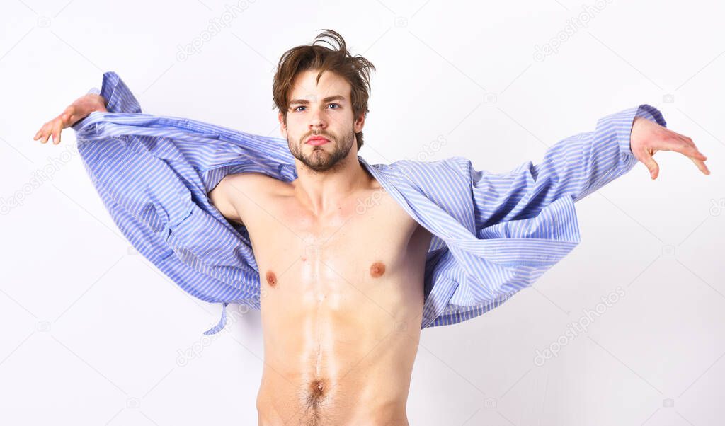 Fit guy with torso and six packs in blue bathrobe.
