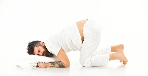 Hipster with sleepy face lies on pillow, heavy sleeper. — Stock Photo, Image