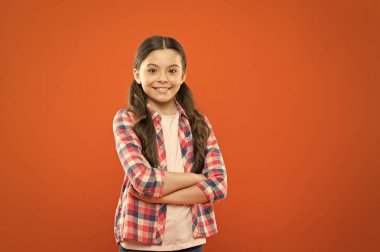 confident girl. kid long hair. small girl checkered shirt. happy child. happy childrens day. childhood memory. little girl orange background. kid fashion. smiling school girl. copy spac