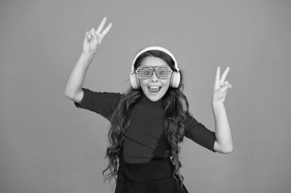 Old school music concept. time for having fun. modern kid enjoy music. feeling stylish and confident. school radio dj. small happy girl listen music in headphones. funny child in party glasses — Stockfoto