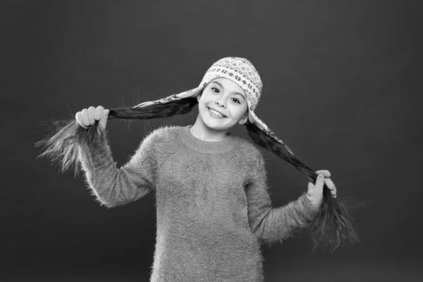 Cute accessories. Adorable baby long hair wear cute winter knitted hat. Girl wear winter theme accessory. Fun and joy. Festive spirit. Cheerful smiling kid. Playful cutie. Winter care for long hair — Stock Photo, Image