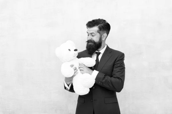 Fabulous gift for little ones. Bearded man hold teddy bear. Businessman with toy gift blue background. Happy boxing day. Cuddly soft present. Gift shop or store. Shopping for gift, copy space — Stock Photo, Image