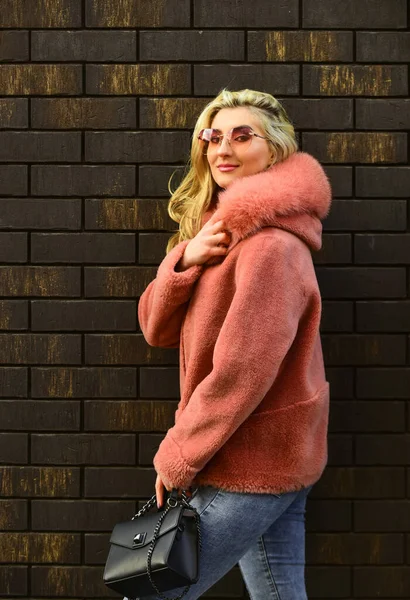 Winter clothes. Fashion as unique as you are. Pink sheepskin coat. Fancy chic coat. Natural wool sheepskin coat. Fur on hood. Stay warm and fashionable. Glamorous lady. Woman wear furry coat — Stock Photo, Image