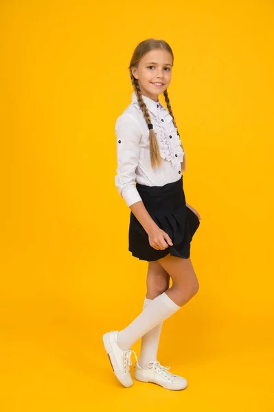 Estilo de moda de la escuela. Estudiante de aspecto inteligente fondo amarillo. concepto de educación moderna. de vuelta a la escuela. Niña de uniforme. belleza pura. niño después de clases. estudio en casa — Foto de Stock