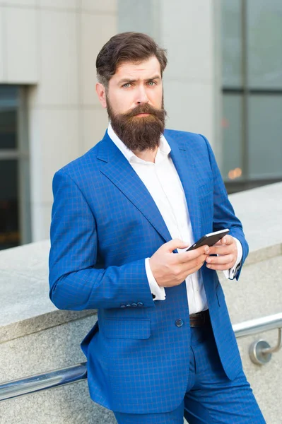 Text messaging. Bearded man with smartphone. Handsome cool businessman using smartphone. Send message. Audio message service. Mobile communication. Email message. Contact list. Online business