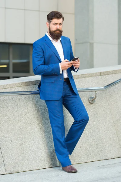 Send message. Mobile communication. Contact list. I can not imagine life without smartphone. Text messaging. Online business. Bearded man with smartphone. Handsome cool businessman using smartphone