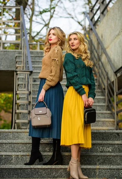 Sweater skirt trend. Completing each other. Matching outfits. Women sisters outdoors stairs background. Vogue concept. Girls blonde wear matching clothes. Matching colors. Personal stylist service — Stock Photo, Image