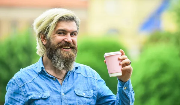 Great morning meal. Coffee on the go. man with a cup of coffee outdoors. Handsome calm bearded man outdoors with a cup. Man drinking hot coffee. tourist relaxing in park drink tea or coffee