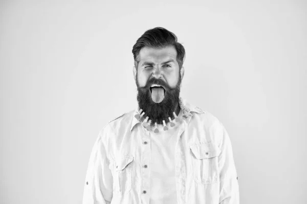 Going crazy. hairdresser concept. man clothespin on beard. brutal male put clothespin with hearts on beard. bearded man hipster casual style. Laundry after washing. hair drying at barbershop — Stock Photo, Image