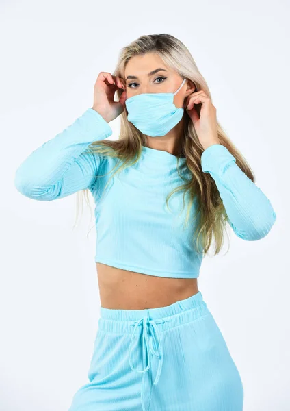 feeling blue. coronavirus health protection. girl in respirator mask isolated on white. doing sport while quarantine. blonde female wear medical mask on face. fit woman wear protective mask
