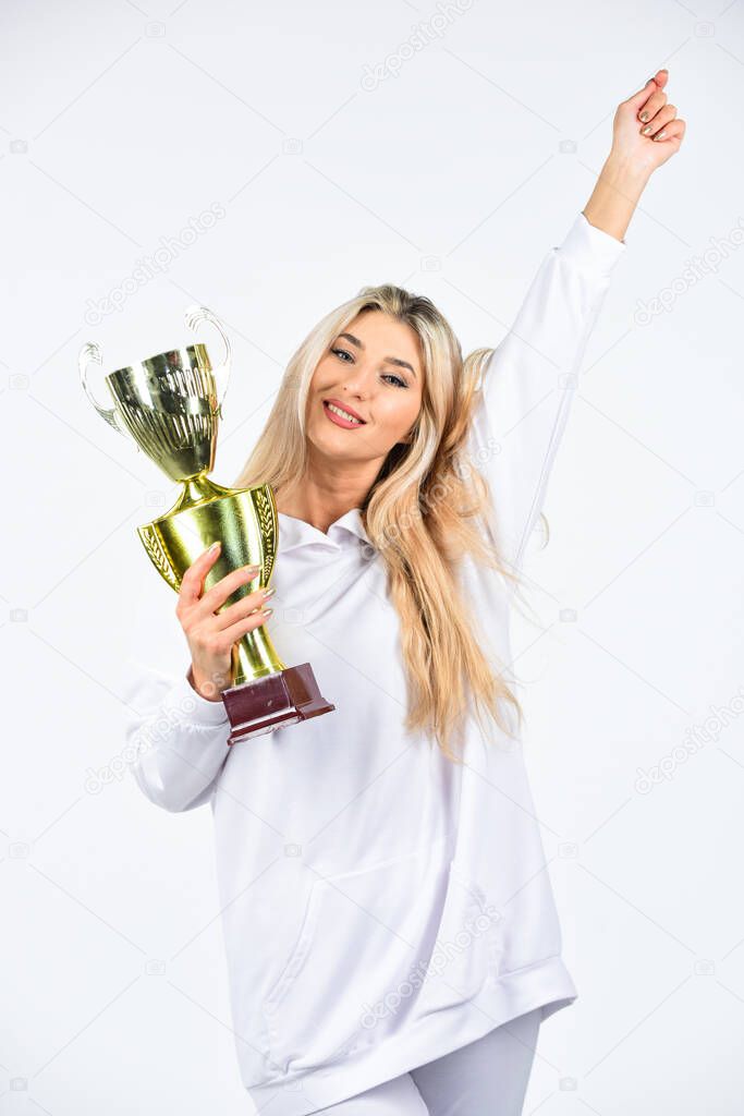 happiness. win the award. this is the victory. congratulations concept. female competition winner. happy sportswoman. showing her trophy. sport success. successful fitness woman hold champion cup