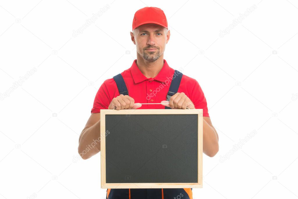 qualified repairman offers his services. male worker in cap hold blackboard. board for copy space. builder service advertisement. best offer ever. move out or relocation loader